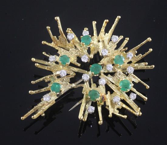 A 1970s 18ct gold, emerald and diamond set stylised flower head brooch, 58mm.